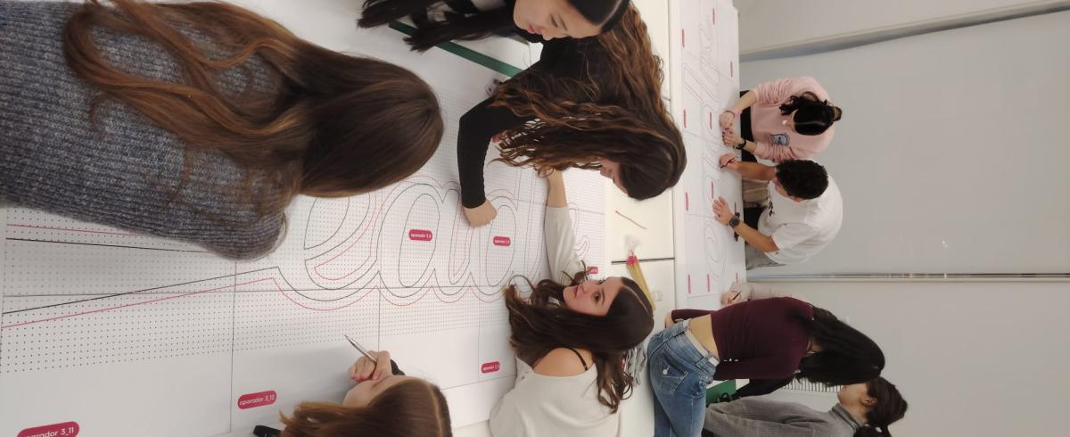 Foto alumnes treballant en un projecte conjunt de pidod